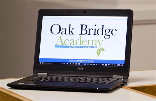 Photo of laptop with Oak Bridge Logo